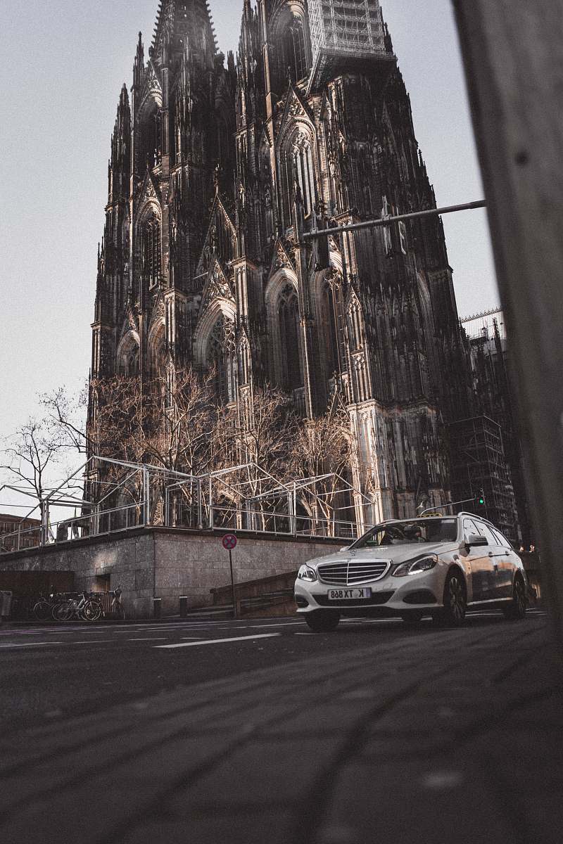 cologne gray car on asphalt road near castle during daytime church