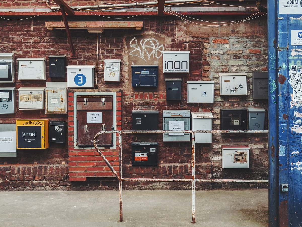 cologne metal boxes on brown brick wall machine