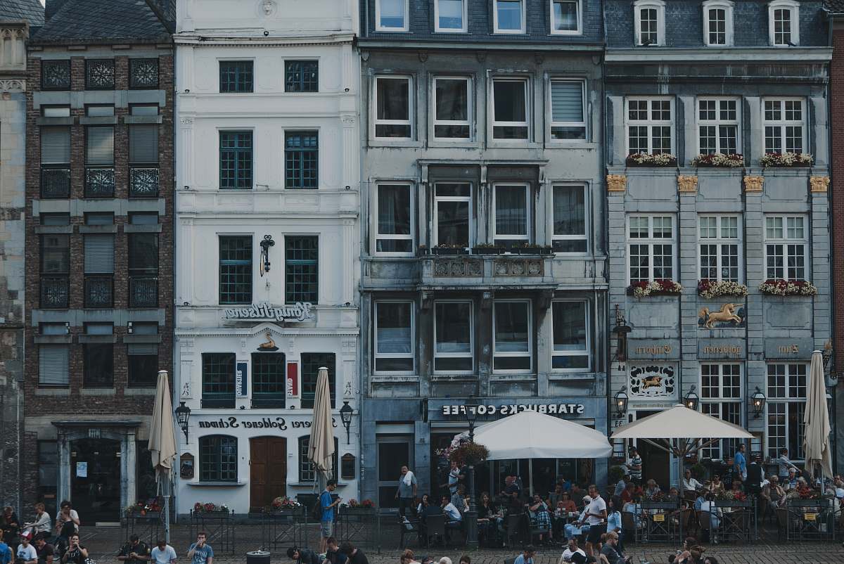 restaurant white patio umbrellas in front of buildings aachen