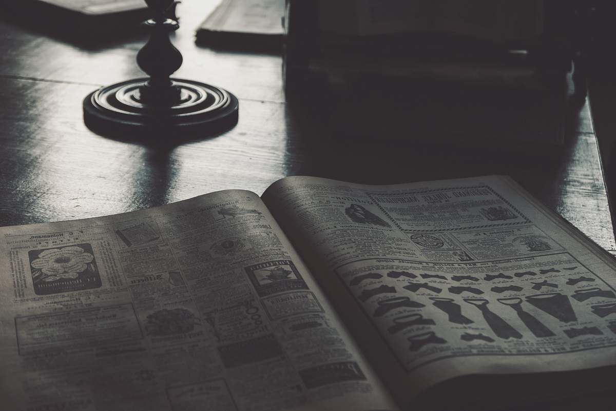 book opened brown book newspaper