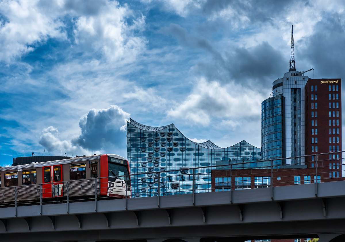 germany train running on rail near buildings during daytime building