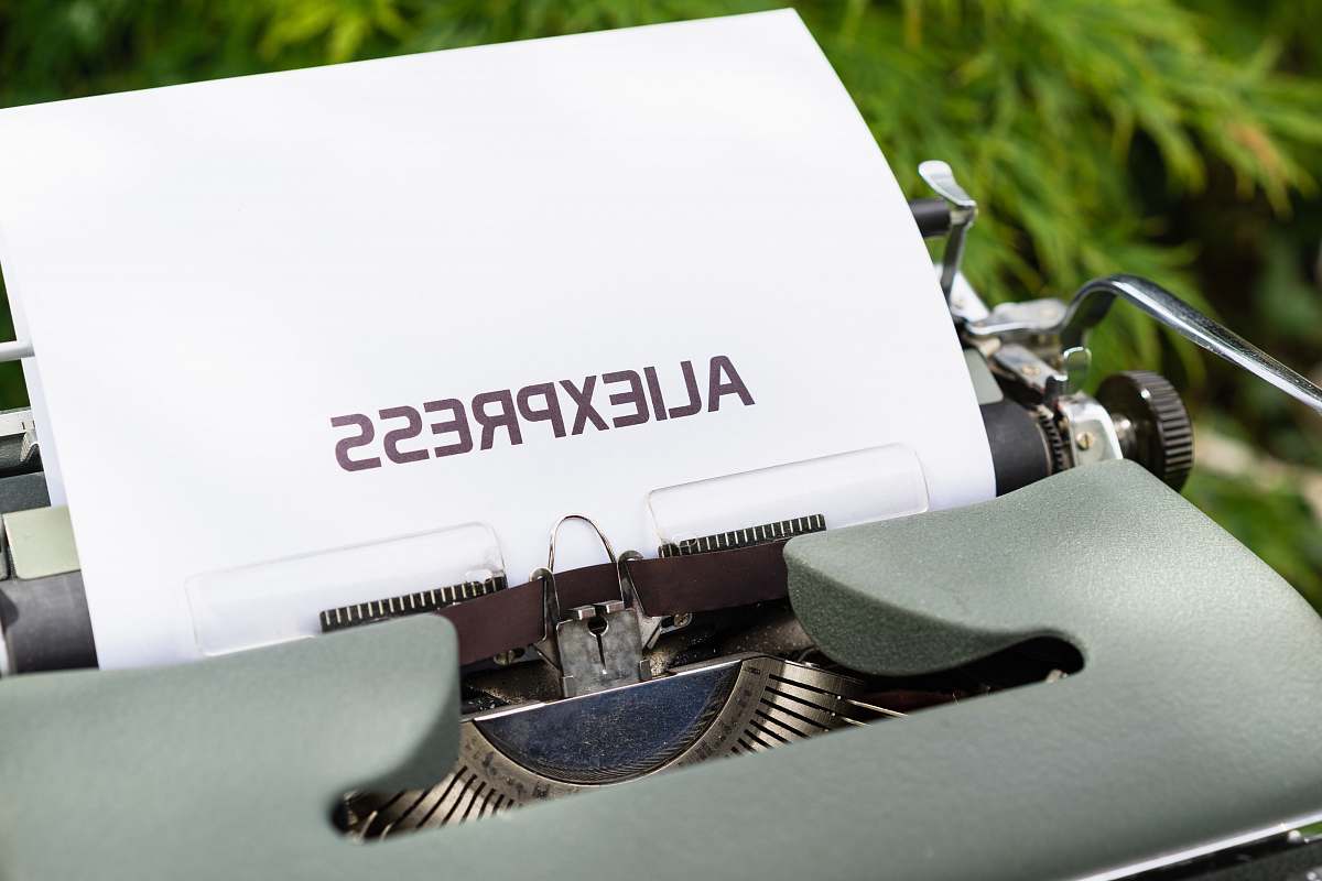 word white and black typewriter on green grass during daytime transportation
