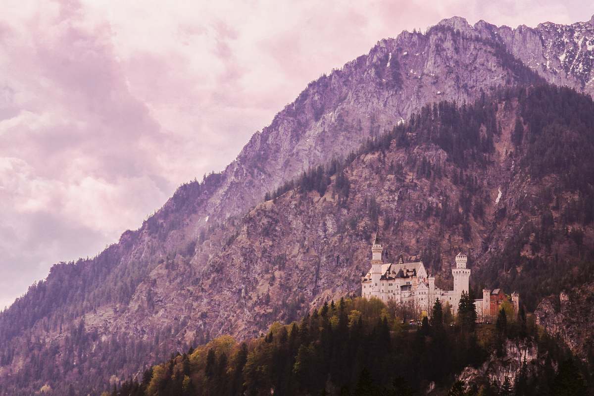 nature white building near mountain during daytime mountain range