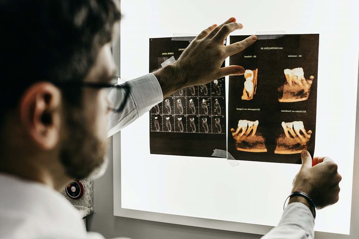  person in gray long sleeve shirt holding black tablet computer 