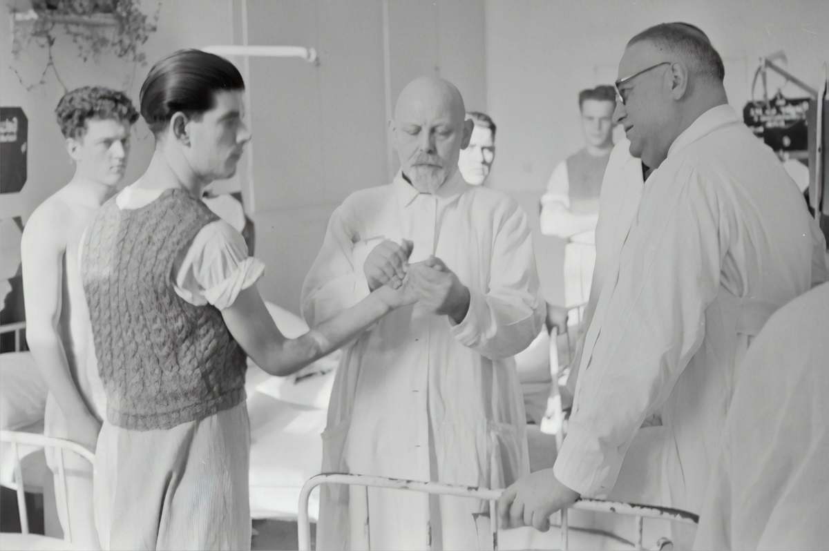 human grayscale photography of man in lab gown grey