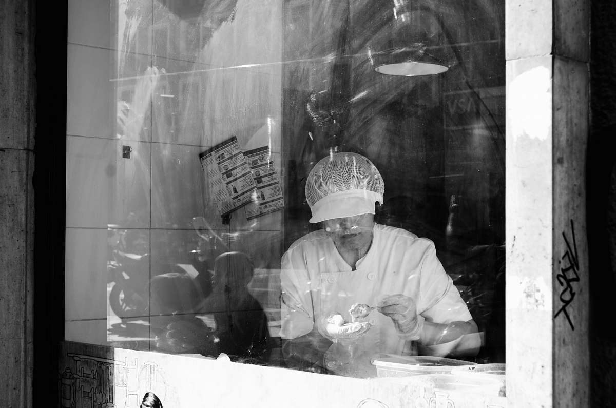 apparel grayscale photography of person working inside room clothing