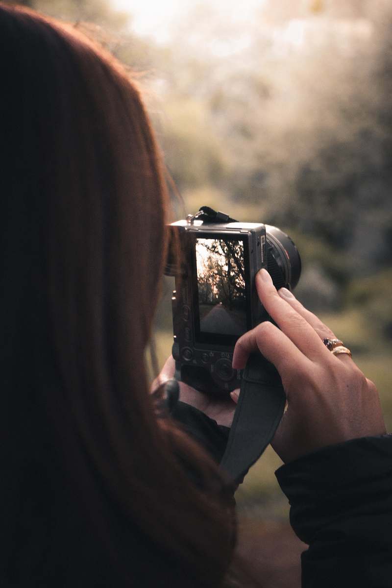 person black DSLR camera human