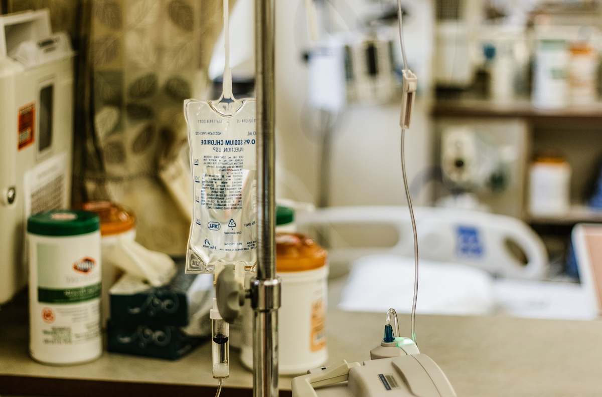 illness selective focus photography of IV stand infusion