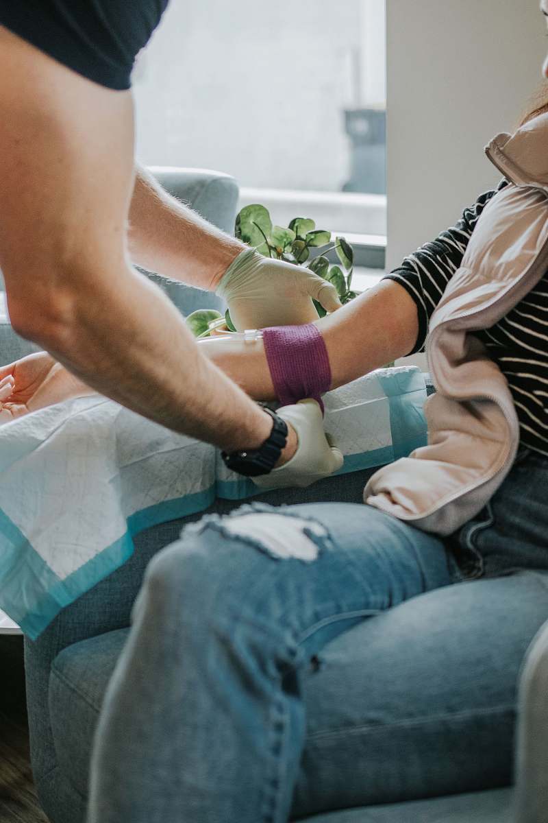 person person tying a tourniquet on left arm human