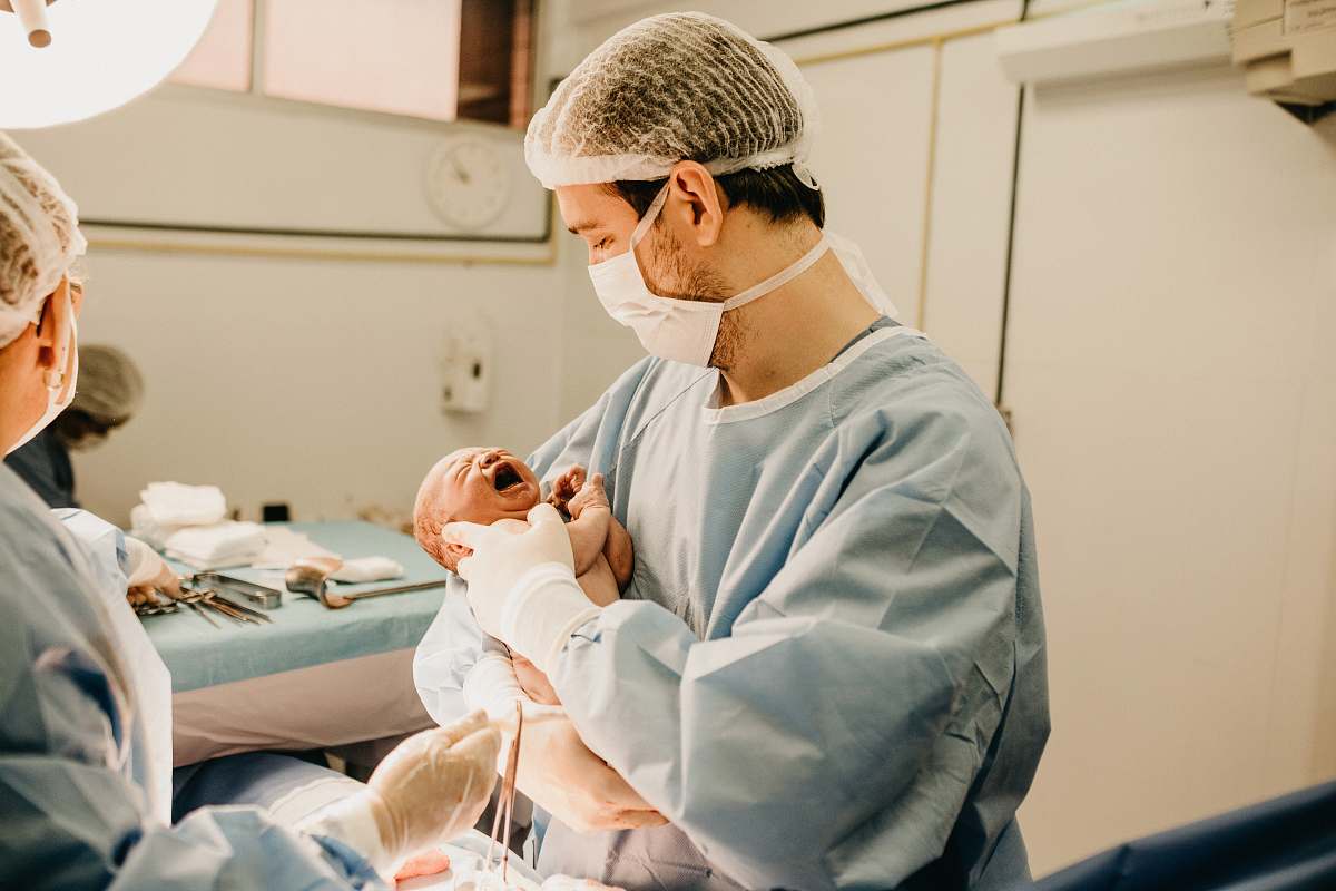 person shallow focus photo of person carrying baby human