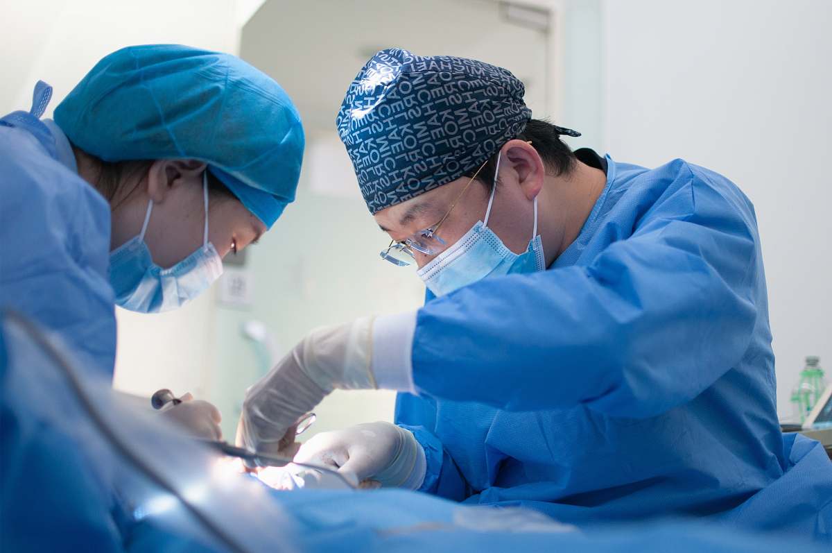 clinic woman in blue scrub suit holding a baby hospital