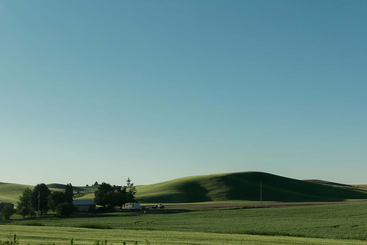 field house in the middle of fields and mountains spokane