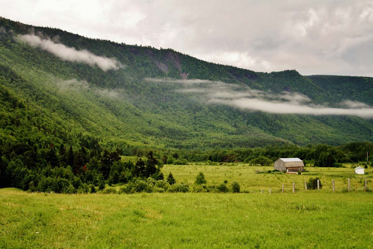 farm brown house near mountain peak pasture