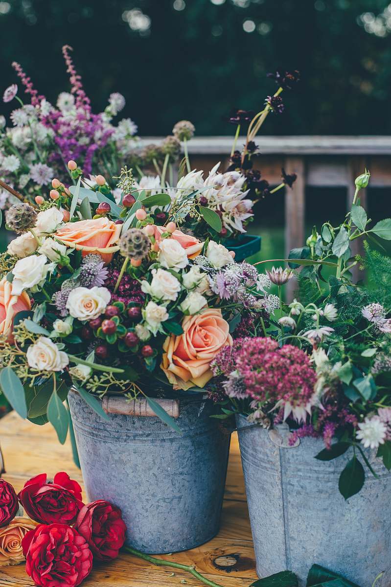 flora assorted flowers on gray metal bucket floral