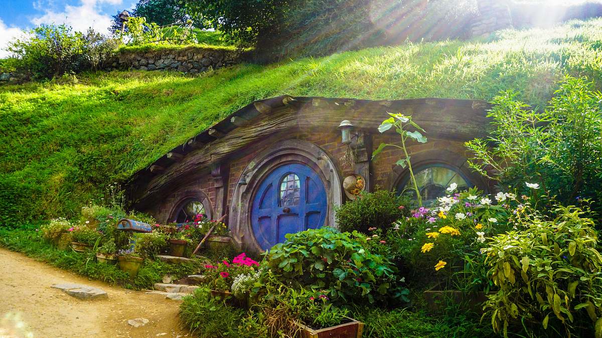 cottage underground house covered with green grass and plants outdoors