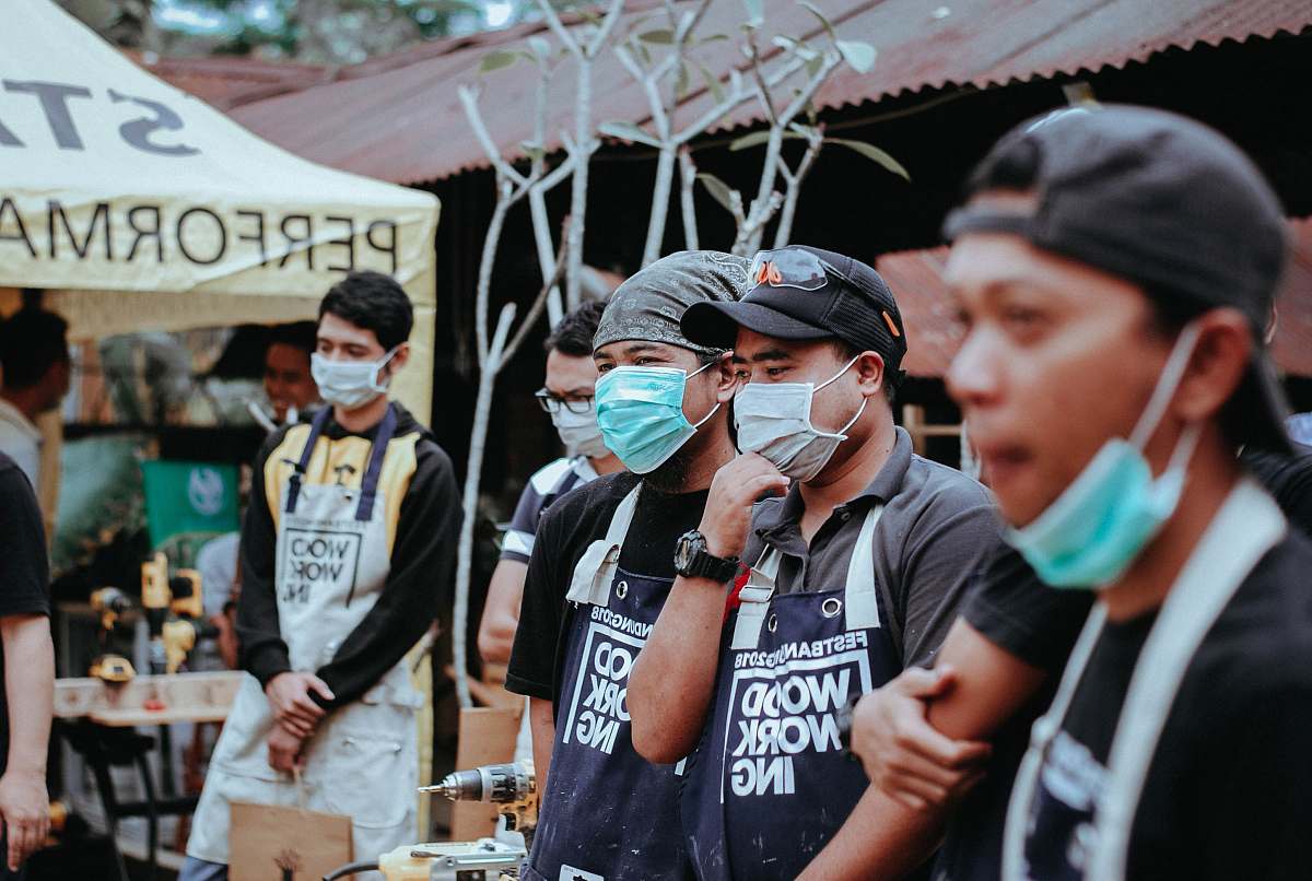 person four men using green and gray face mask apparel