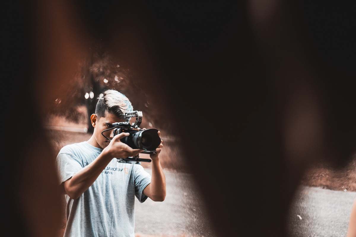 person man holding black camera camera