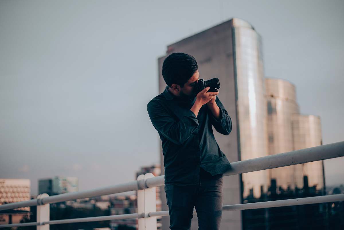 person man in black shirt using DSLR camera guatemala