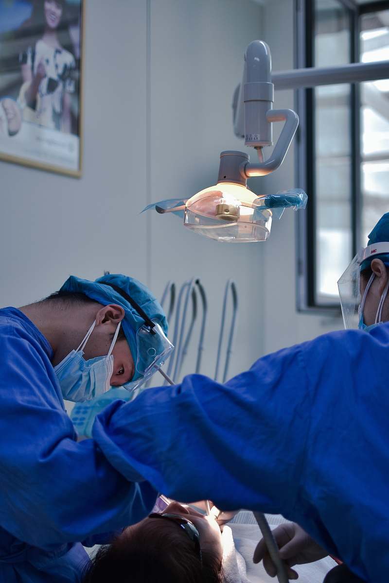person man in blue scrub suit wearing white mask doctor