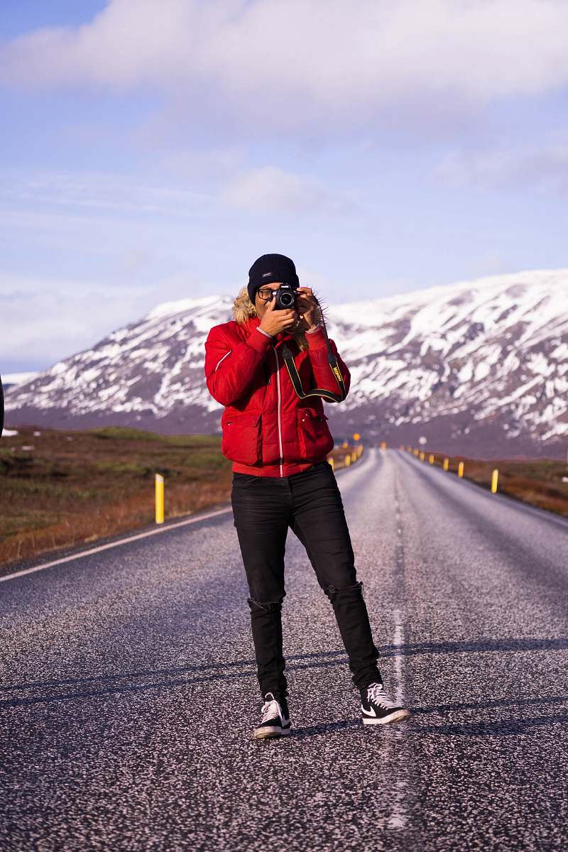 person man taking photo on road photo
