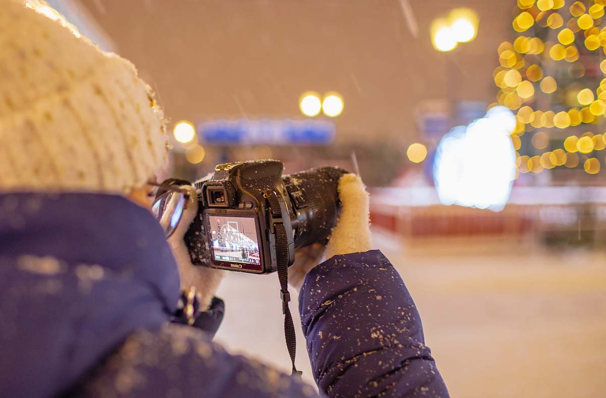 person person holding DSLR camera camera