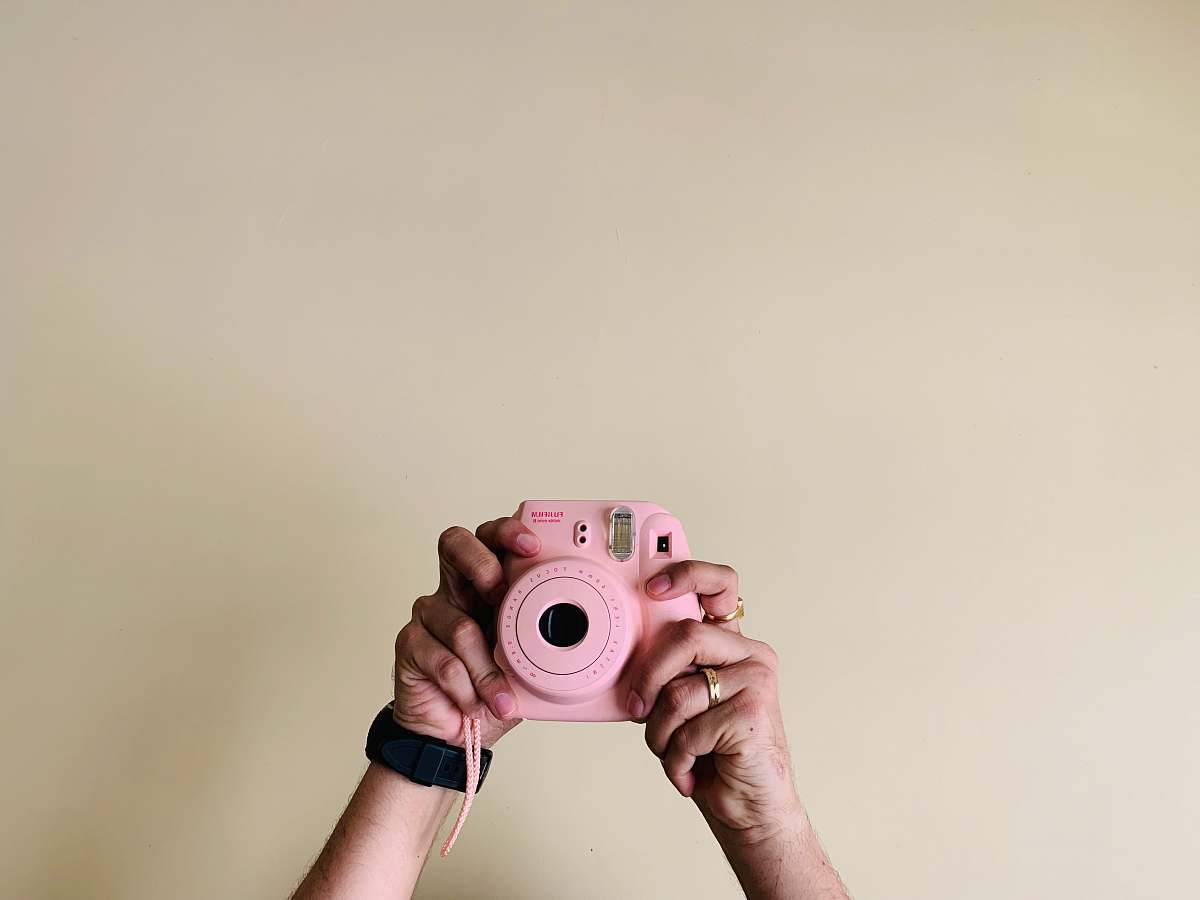 person person holding pin camera electronics