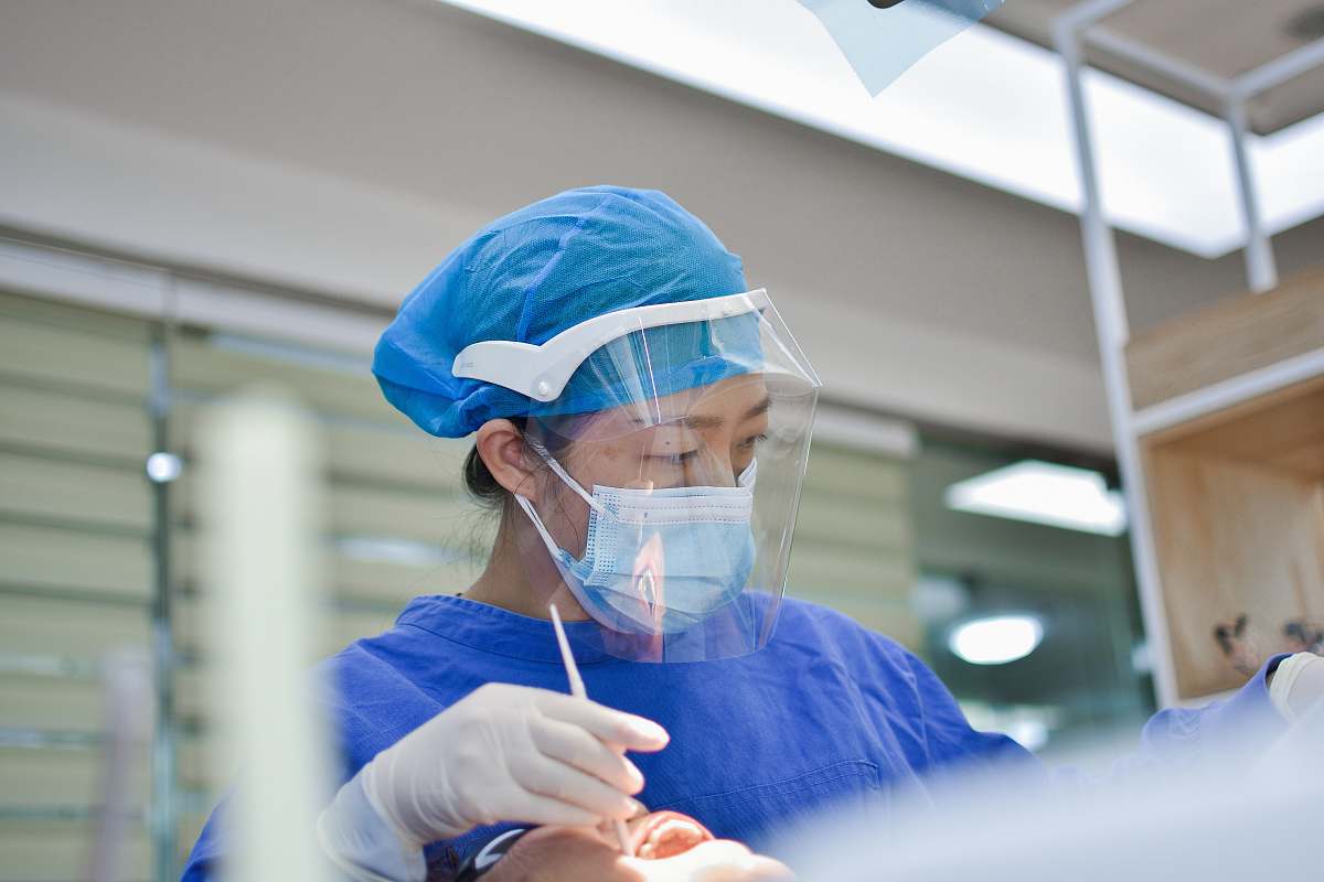 person person in blue scrub suit wearing white mask doctor