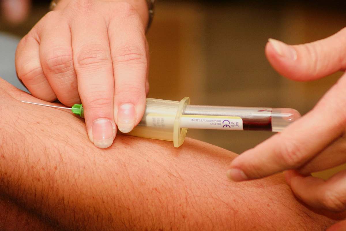 medical person injecting syringe injection
