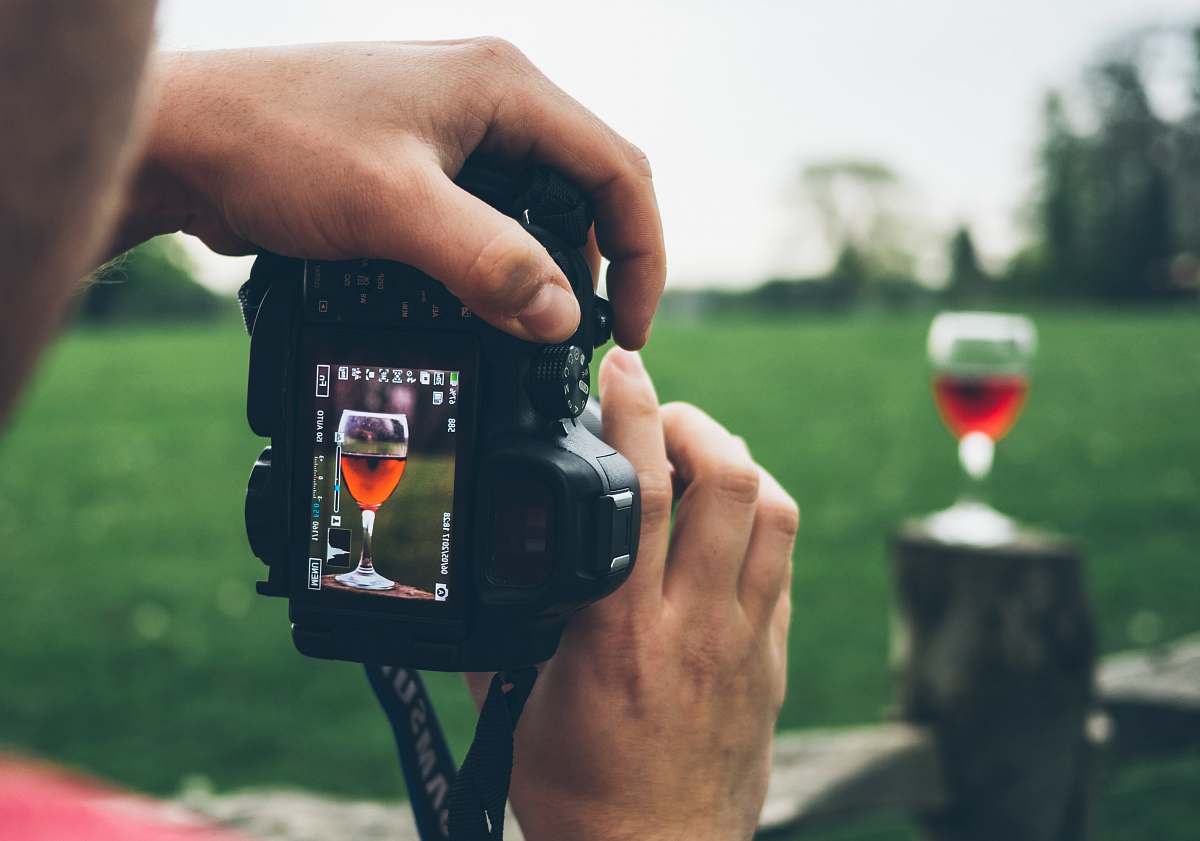 person person taking photo of wine goblet people