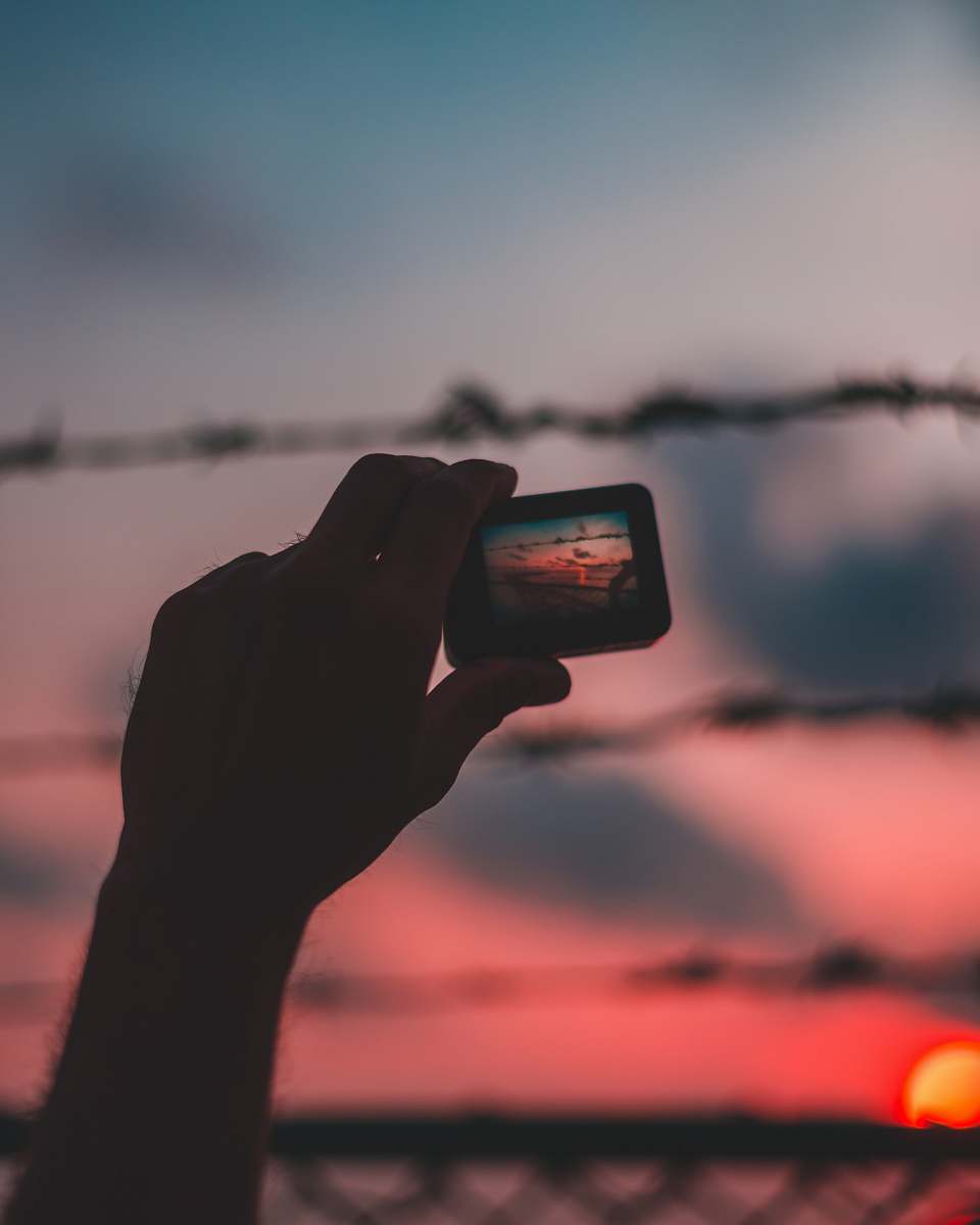 person selective focus photo of person holding action camera photo