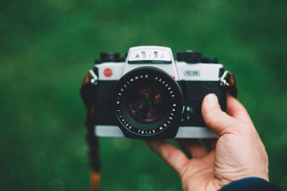 person selective focus photography of camera electronics