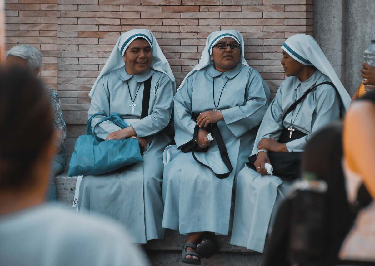 person three nuns sitting apparel