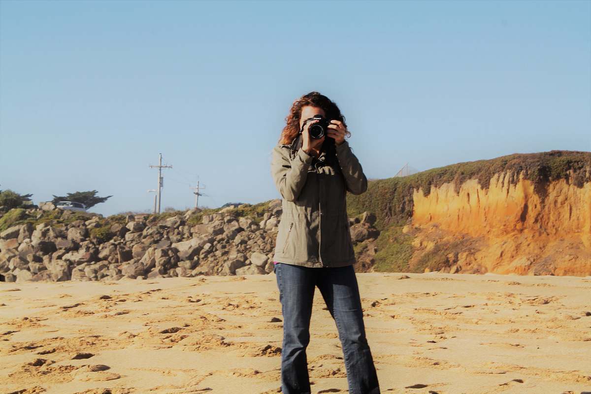 person woman holding camera photographer