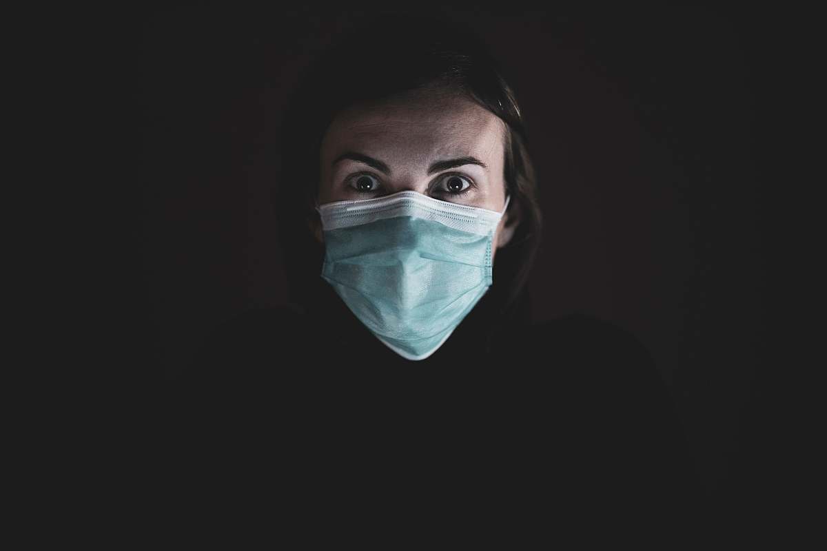 person woman in black hijab and white face mask doctor