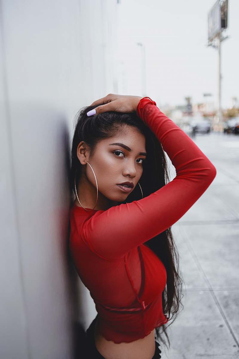 person woman leaning on wall face
