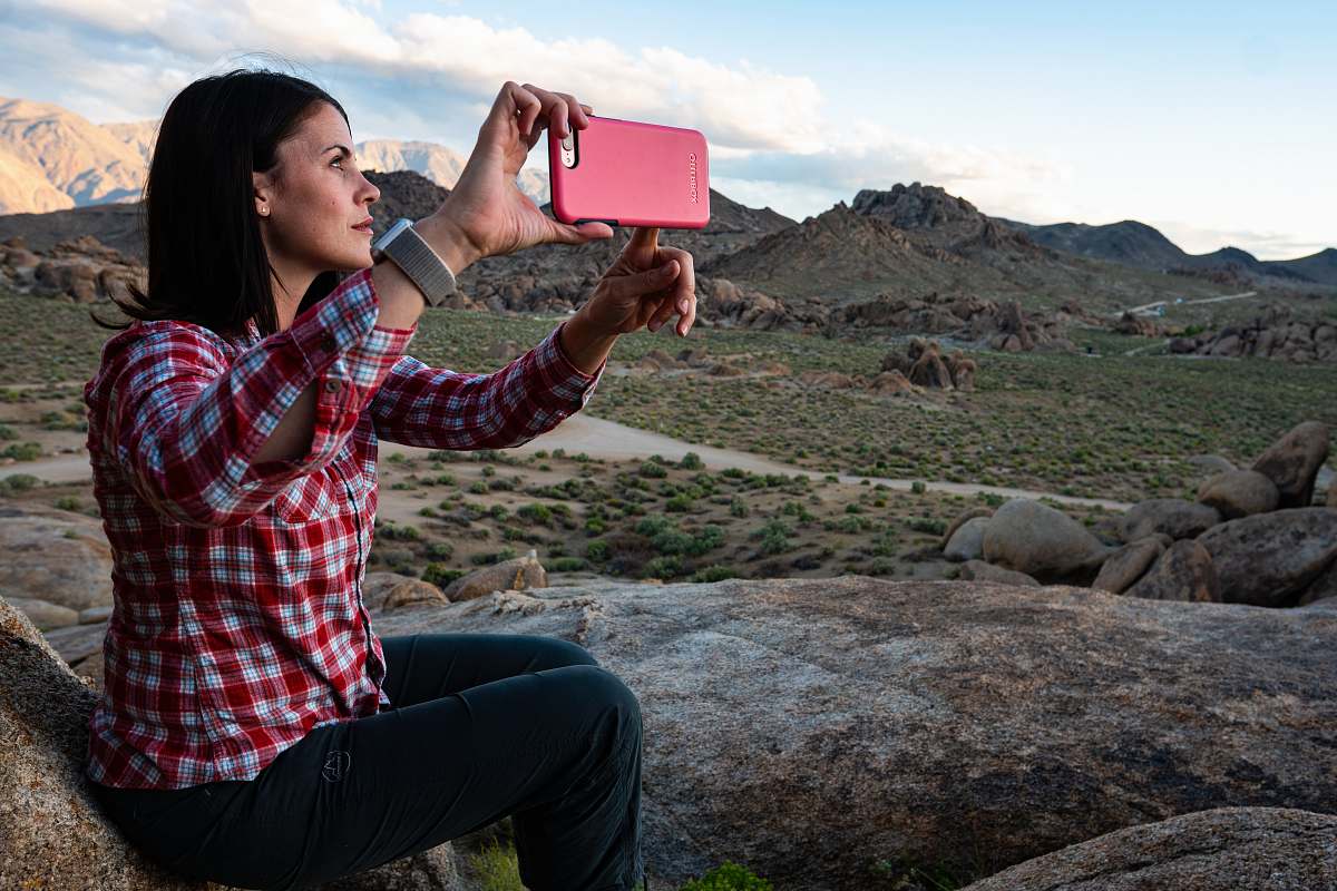 person woman sitting holding smartphone face