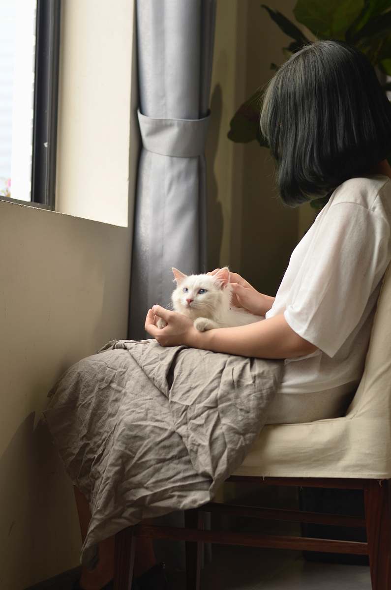 person woman sitting with cat on lap doctor