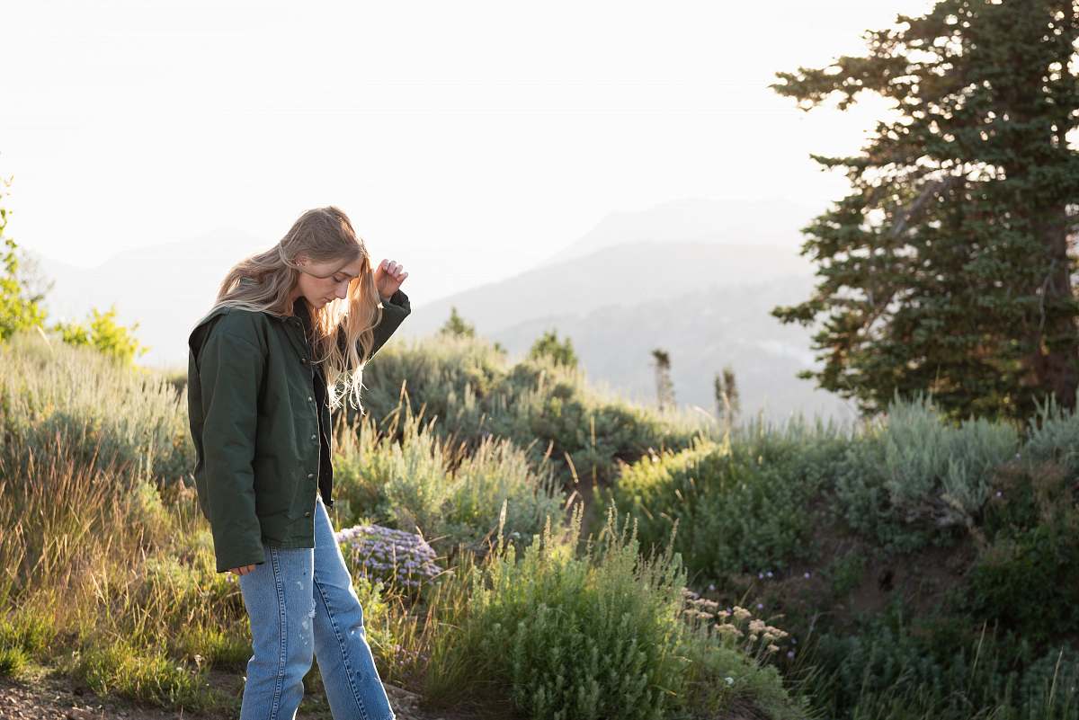 person woman standing on ground with plants photo