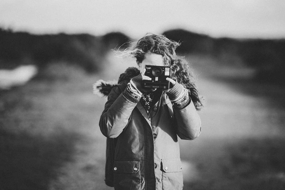 black-and-white woman taking photo grey