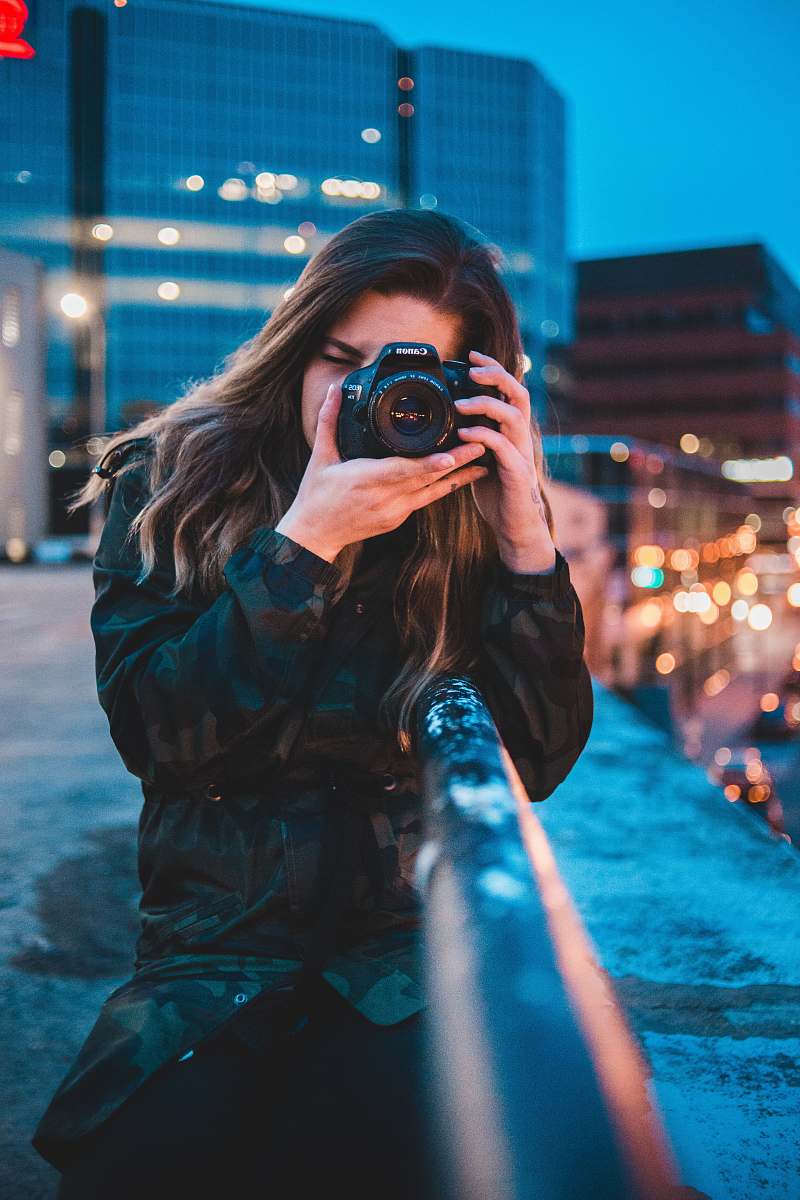 person woman using camera camera