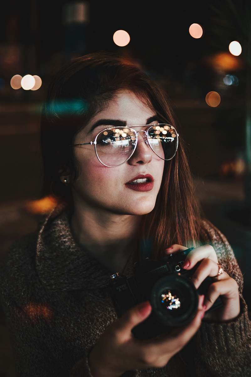 people woman wearing silver-colored Aviator-style sunglasses holding camera bokeh photography person