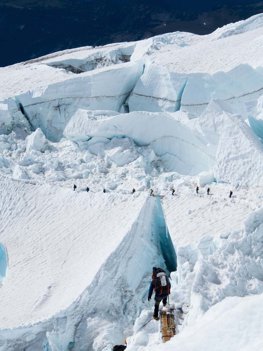 mountain people skiing on snow covered mountain glacier