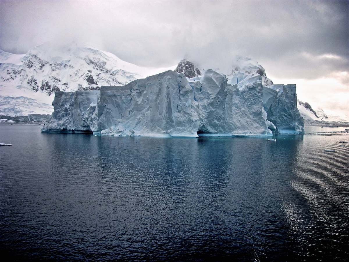 iceberg white iceberg near white mountains antarctica