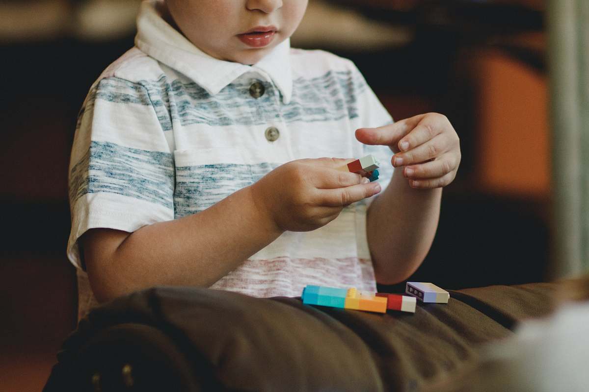 human boy holding block toy person