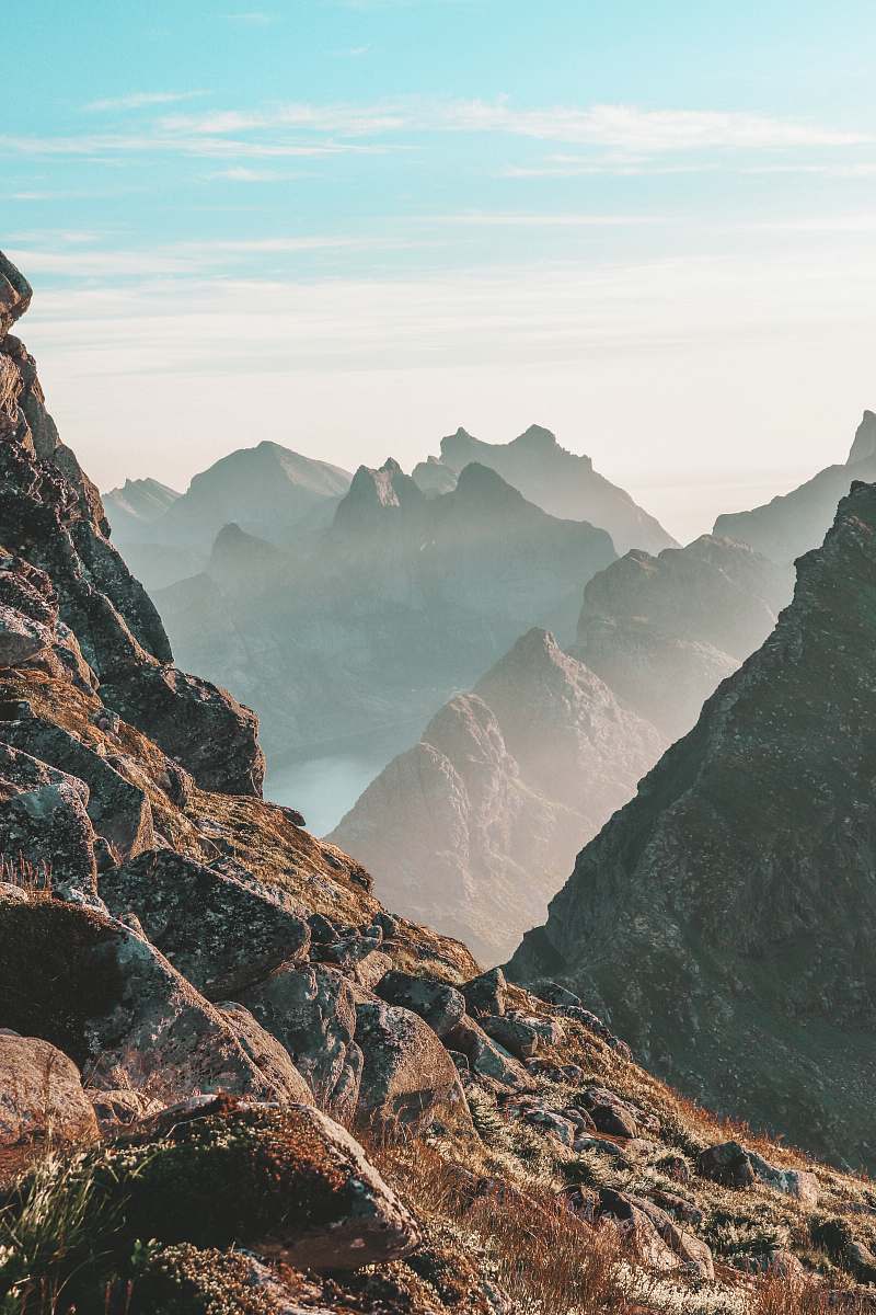 nature closeup photo of rocky mountain under blue and white sky norway