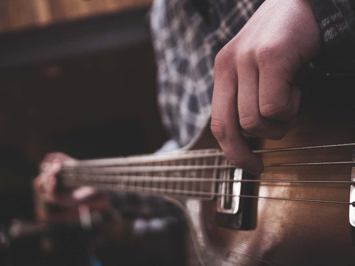person person playing acoustic guitar strings