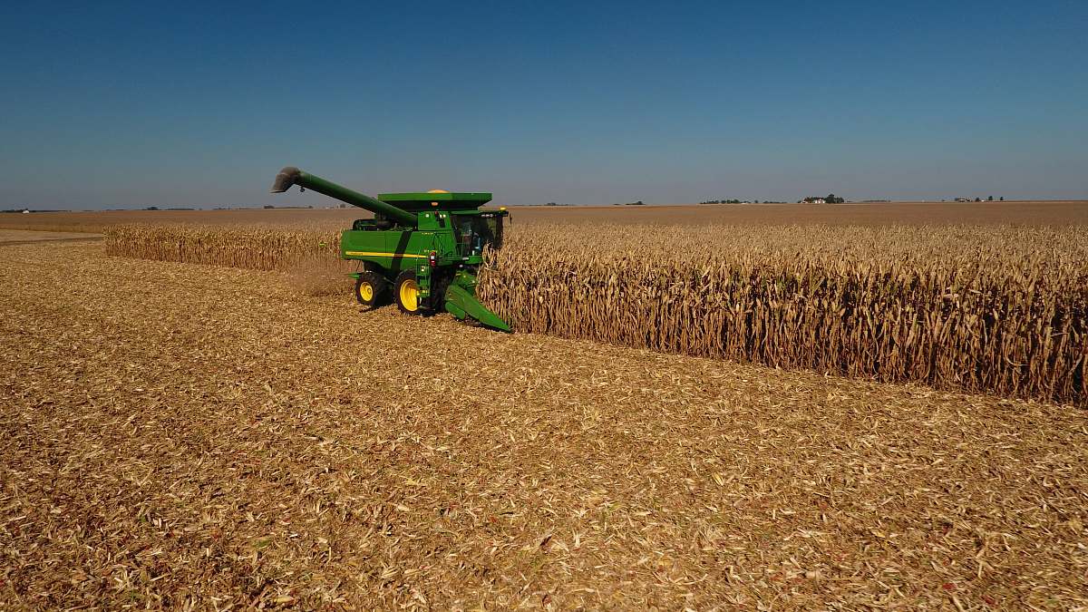 outdoors John Deere plow beside dried field countryside