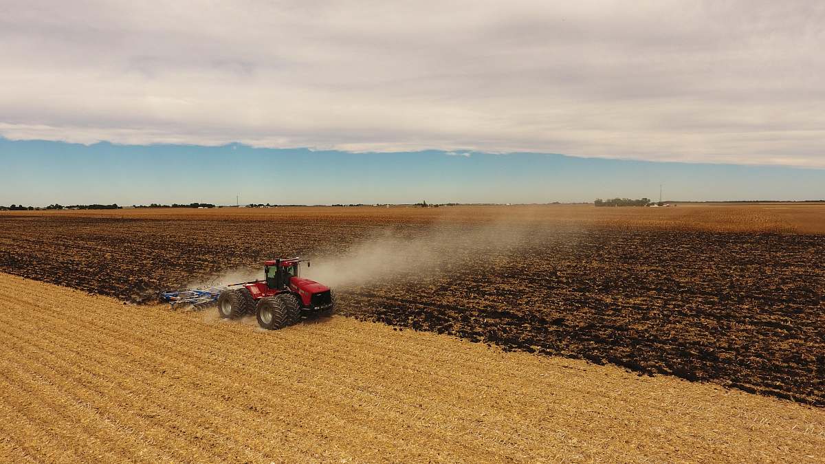 countryside red tractor on field outdoors