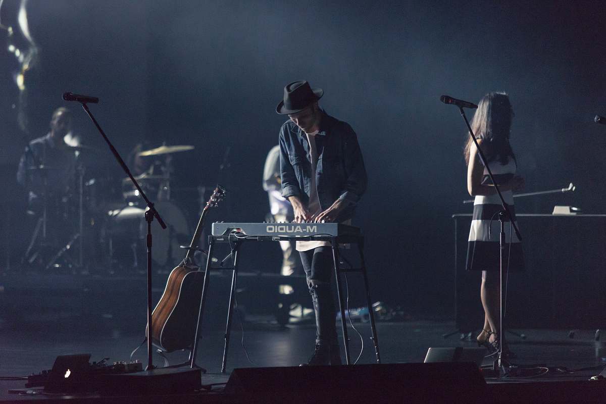 person man playing electronic keyboard concert