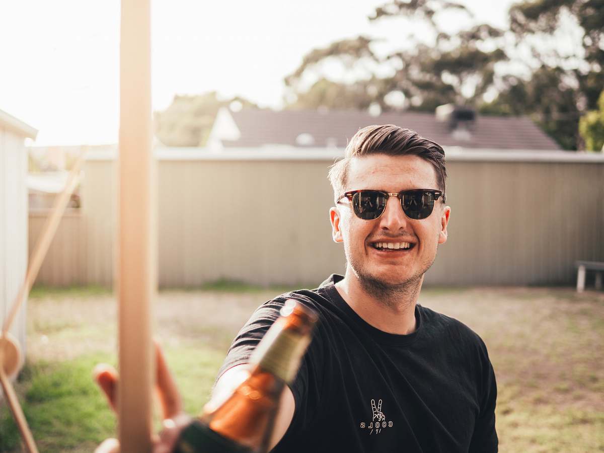 human man smiling while taking photo person
